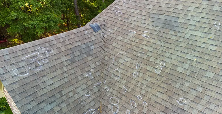 Roof storm damage inspections showing defects in shingle roof material